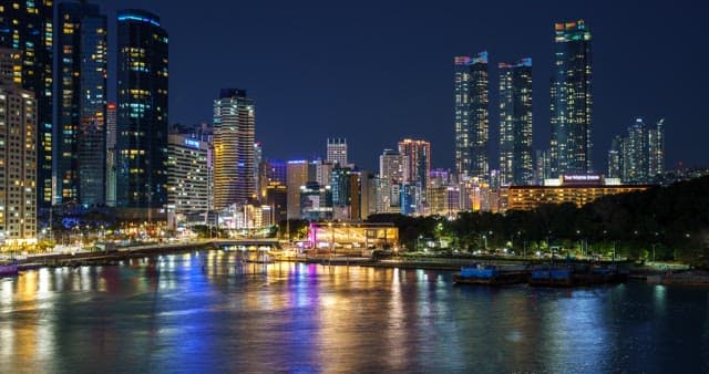 Colorful night view of the port with skyscrapers visible