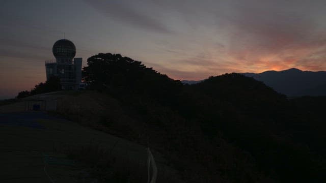 Sunset over observatory on a hillside