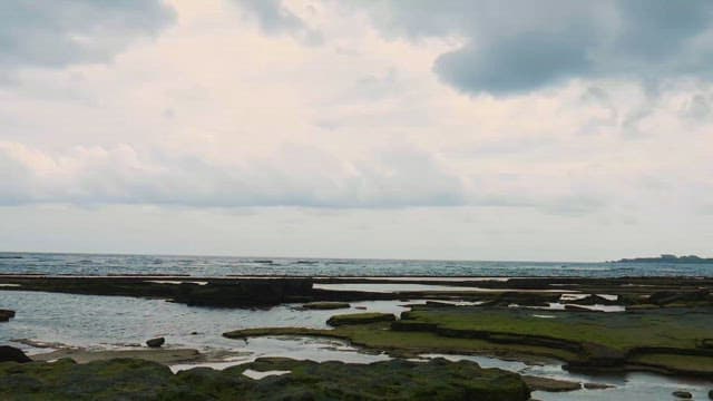 Serene Coastline Under Cloudy Skies