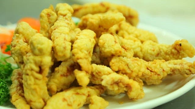 Sweet and sour sauce poured over fried meat