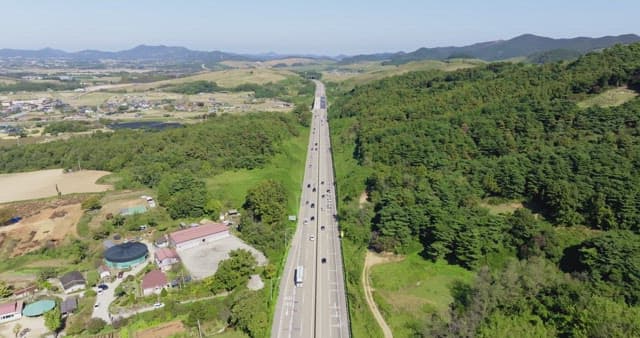 Highway cutting through lush green forests