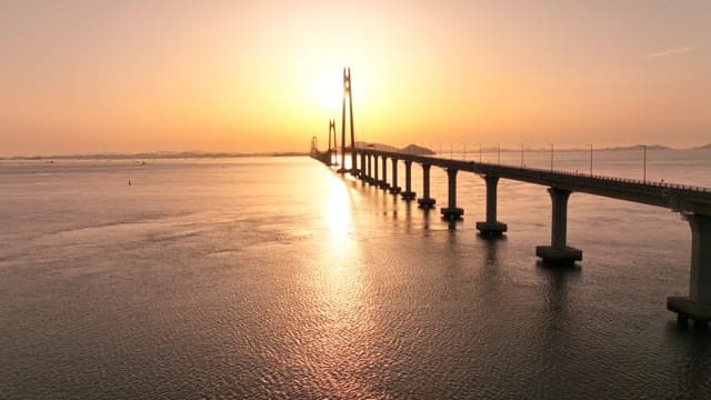 Bridge over the sea at sunset