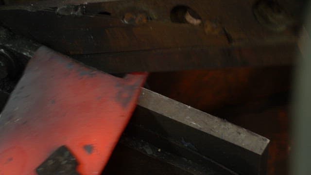 Forging a glowing hot metal piece