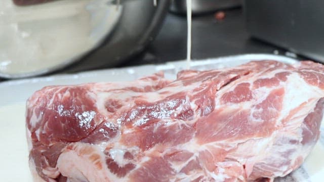 Fresh meat being marinated with white sauce