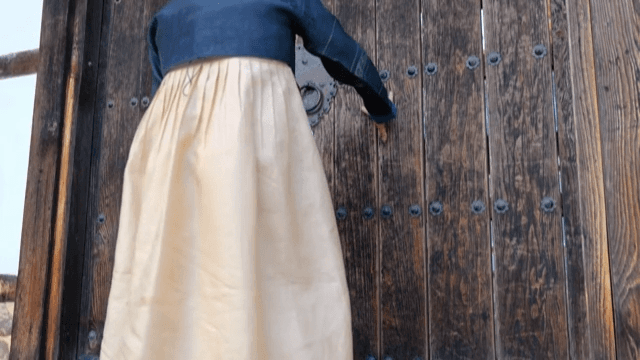 Woman Wearing Hanbok Entering a Korean Traditional House
