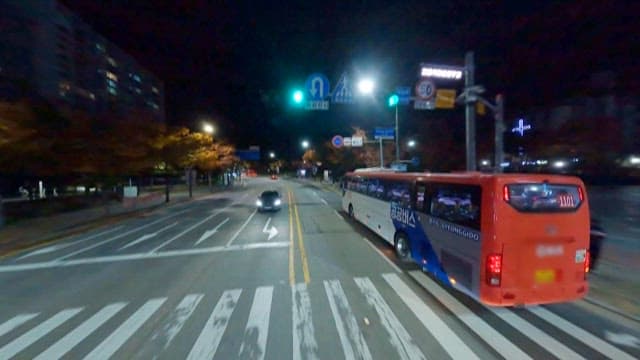 Bus Stopped at a Stop to Pick up Passengers at Night