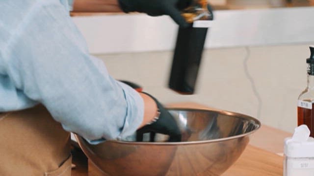 Adding Soy Sauce to Glass Noodles in a Bowl