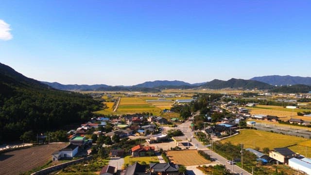 Rural farm village surrounded by autumn mountains