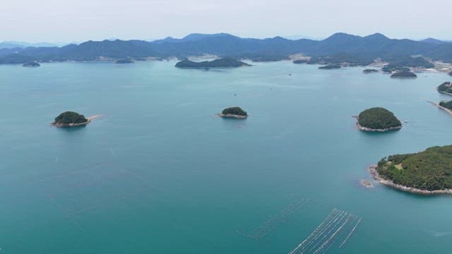 Small islands scattered in the calm sea from aerial view