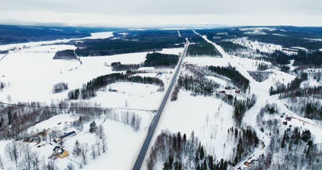 Snow-covered landscape with winding road