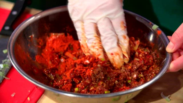 Mixing raw pollack seasoning with red pepper powder