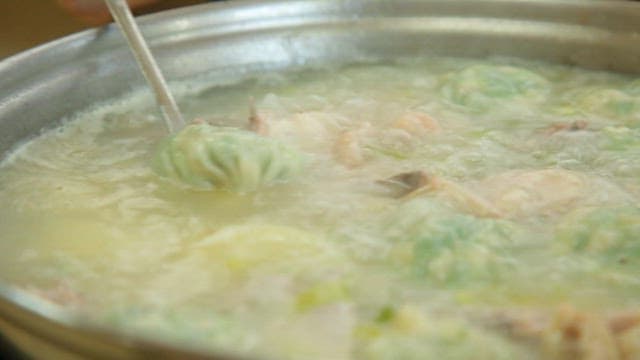 Dumplings boiling in a chicken soup