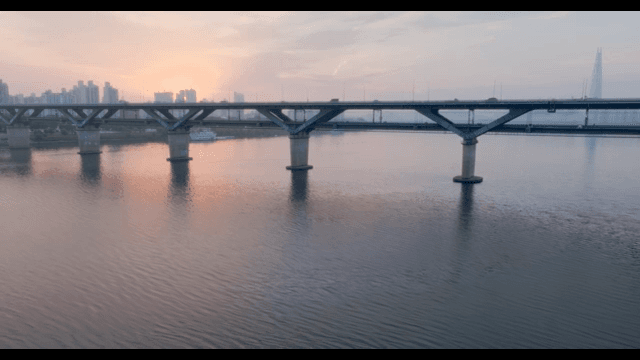 Sunset over a bridge and city skyline