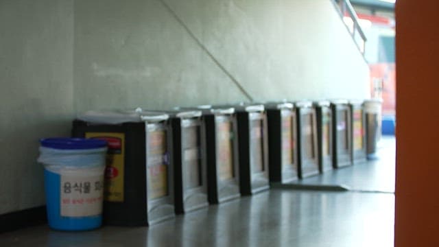 Row of trash bins in an indoor hallway