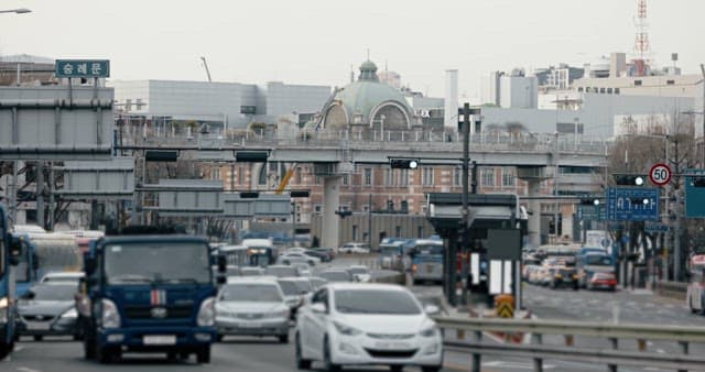 Busy City Traffic with Historic Building