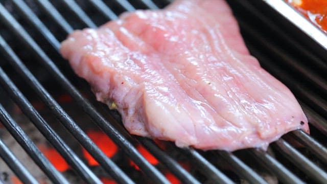 Fresh pig uterus grilled on a barbecue grill