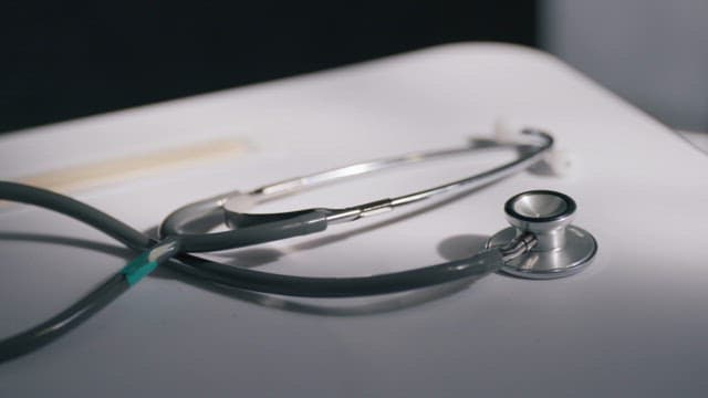 Stethoscope and Syringe on an Examination Table