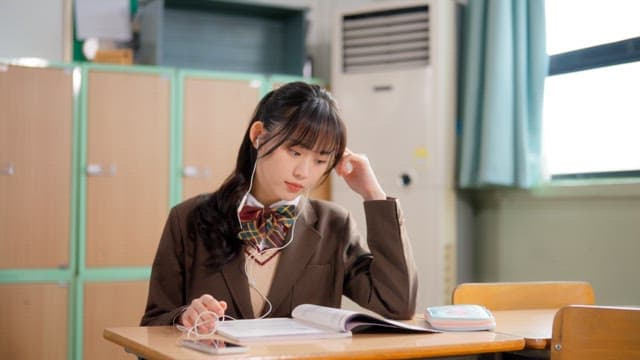 Students studying and sharing earphones