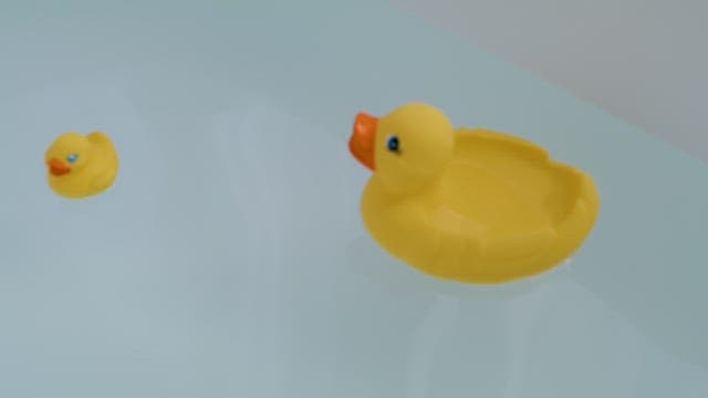 Rubber Duck Floating on a Bathtub Filled with Water