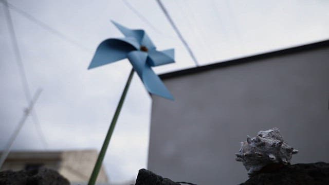 Blue pinwheel spinning in the wind