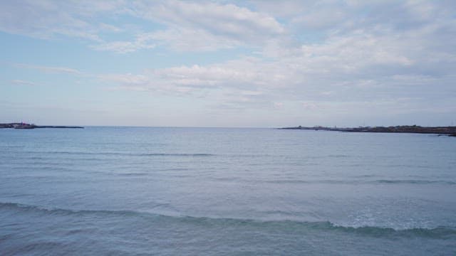 Calm sea under a cloudy sky
