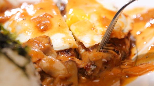 Cutting into a juicy hamburger steak