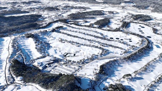 Snow-covered landscape with winding paths
