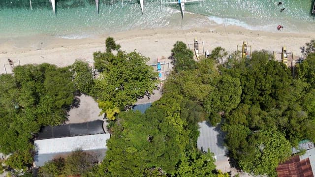 Boats on clear turquoise water by the beach