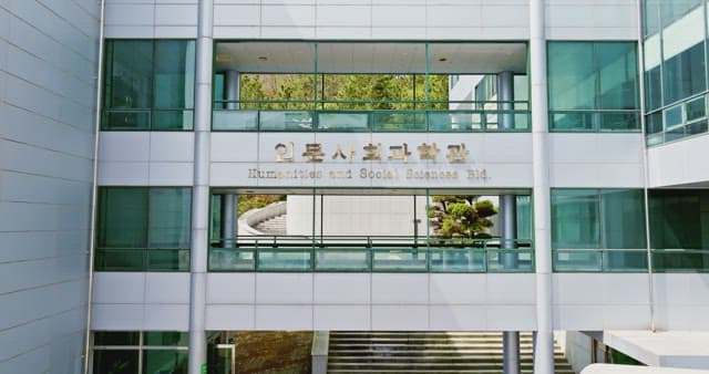Campus building surrounded by cherry blossoms