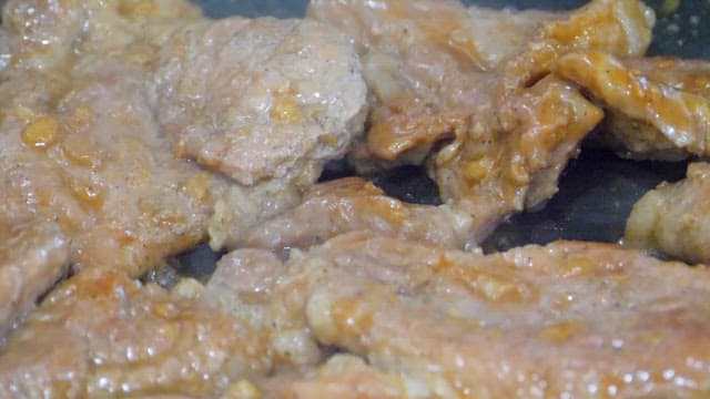 Marinated grilled pork ribs being grilled on a grill