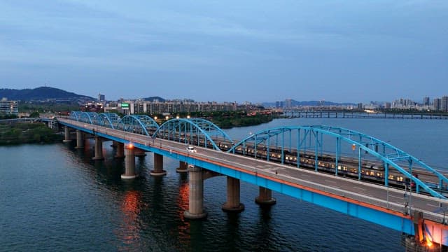 Bridge over a river with city skyline