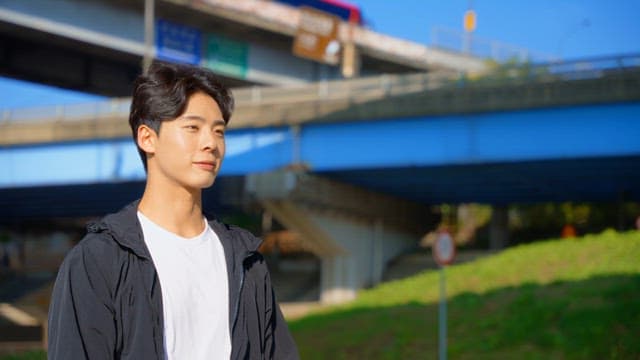 Man stretching under a highway bridge