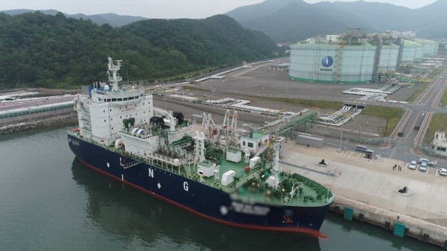 LNG ship docked at an industrial harbor