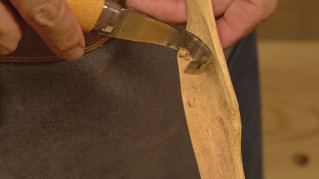 Hand carving wood with a curved knife