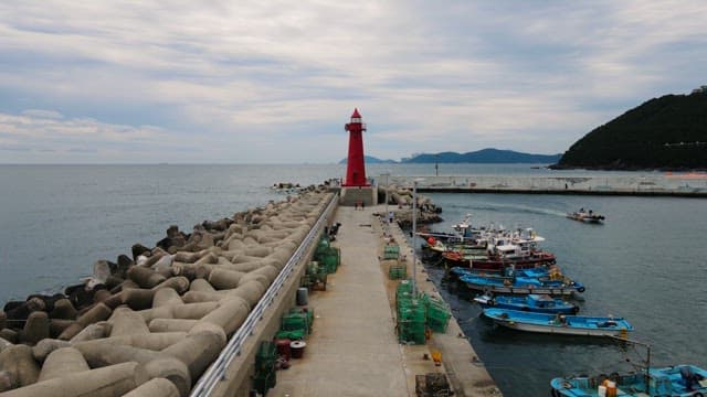 Vibrant red lighthouse on a pier