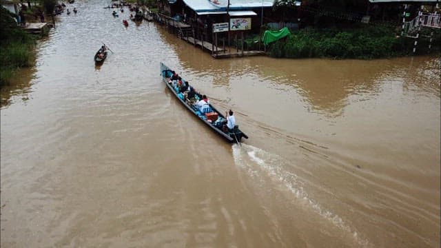 Boats transporting people on a Inle Lake village