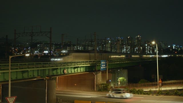 Subway train passing over a bridge in a busy city