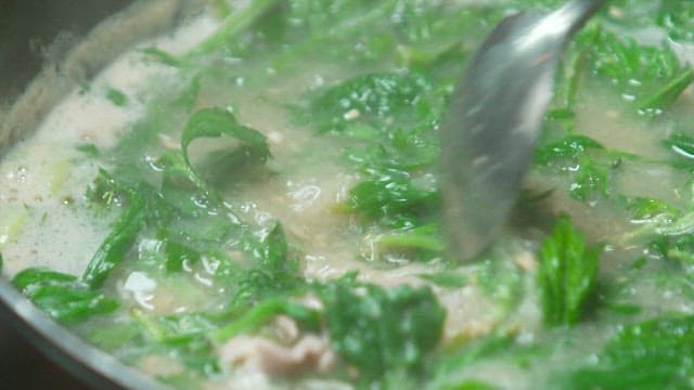 Pork soup with fresh mugwort boiling in a pot