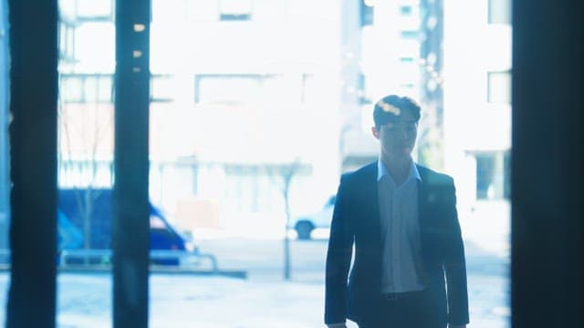 Man in a suit entering a building
