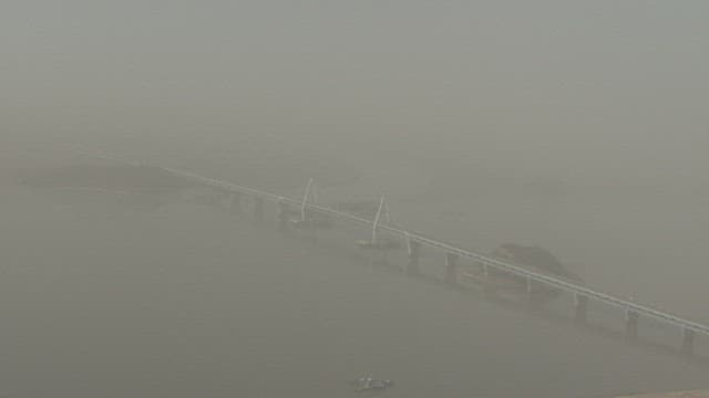 Bridge Over the Calm River in Hazy Air with Fine Dust