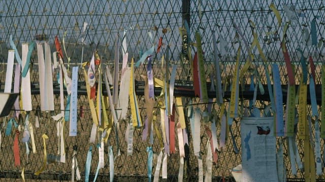 Colorful Ribbons of Wishes on a Fence