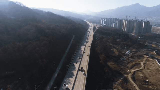 Traffic on Highway Near Urban Development