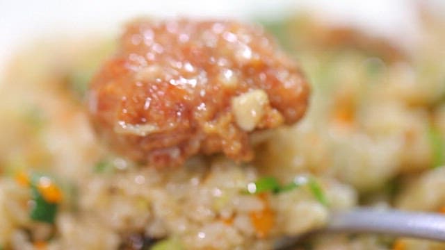 Spoonful of fried rice with meatball