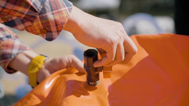 Hand Tightening a Rubber Boat's Air Inlet