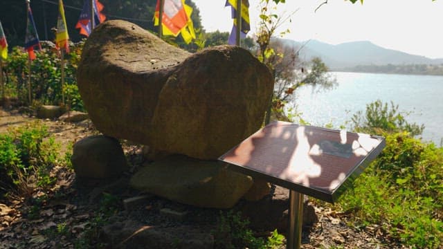 Rock tower surrounded by trees and greenery