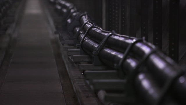 Dark corridor with large pipes in industrial facility