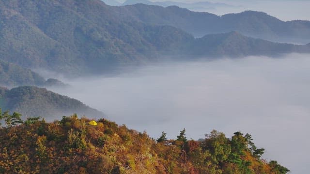 Serene Sunrise atop Misty Mountains