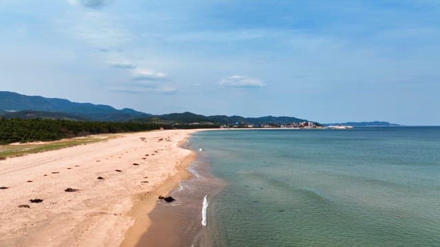 Serene beach with distant mountains