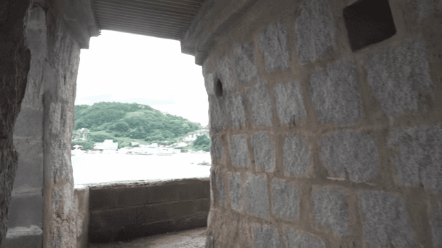 Stone passageway leading to a coastal view