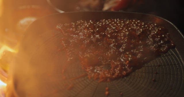 Sizzling squid being cooked on a grill
